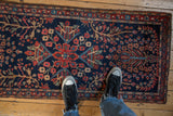 Antique Persian Farahan Sarouk runner, navy field, quatrefoil medallion, madder red florals, with feet.