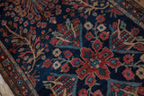 Blossomed madder red and sky blue floral motifs on antique Farahan Sarouk's navy field.