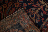 Antique Farahan Sarouk rug showing navy floral pile and intricate geometric woven back.