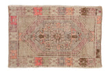 Vintage distressed Oushak rug with a hexagonal medallion in faded pink, aubergine, and silver tones.