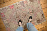 A lifestyle view of the distressed vintage Oushak rug, highlighting its soft texture and colors.