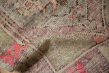 Low, time-softened pile on a vintage Oushak rug revealing its hand-knotted woven foundation.