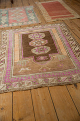 Distressed Kars rug corner with faint foundation, showing magenta, orange, and pawn borders.
