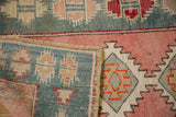 Hand-knotted foundation and intact side cord on the corner of a vintage distressed Turkish rug.