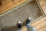Distressed vintage Kars rug runner with lattice pattern, worn knot heads, and platinum tones.