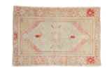 Vintage distressed Oushak rug with a faded lozenge medallion in pale tangerine and ruby red tones.