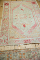 Angled view showing the soft, worn pile of a distressed Oushak rug.