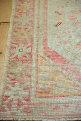 The intact side cord selvage and low, worn pile of a vintage Oushak rug.