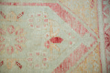 Close-up of the distressed Turkish Oushak weave showing worn pile and visible knot heads.