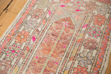 Textured distressed Oushak runner showing magenta highlights on pinwheel and tree of life motifs.