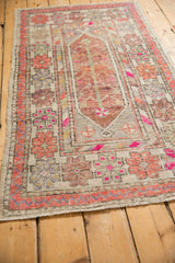 Vintage Oushak runner's floral border, inner patterns, vibrant magenta, and aged pile.