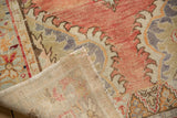 Hand-knotted foundation and distressed pile of a vintage Oushak in blush and sage tones.