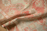 Pliable hand-knotted weave of a distressed Oushak showing its worn texture and soft colors.