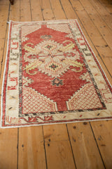 Distressed Oushak runner with a cherry red field and geometric lattice patterns viewed lengthwise.