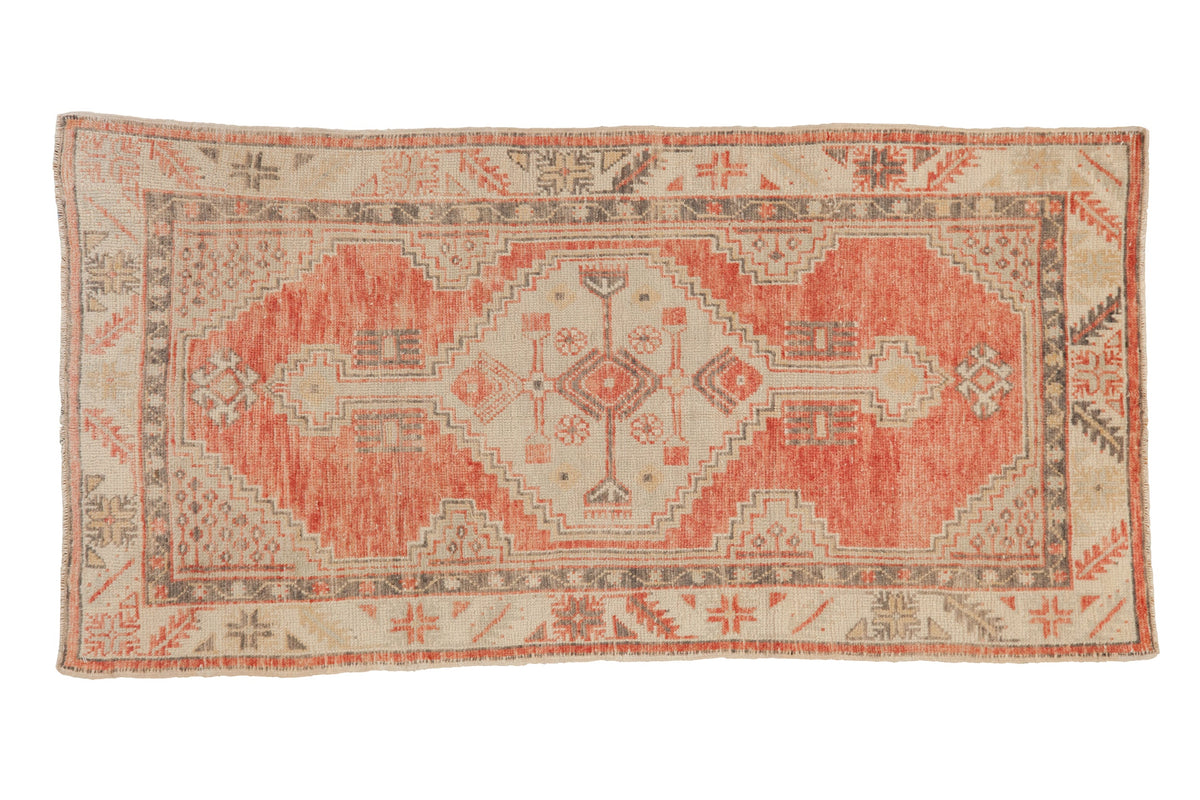 Vintage distressed Oushak rug runner with a stepped hexagonal medallion in pale cantaloupe, ivory, and charcoal.