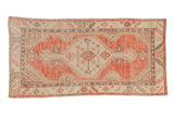 Vintage distressed Oushak rug runner with a stepped hexagonal medallion in pale cantaloupe, ivory, and charcoal.
