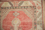 Corner detail of a distressed Oushak rug showing even wear on the stepped melon and charcoal design.