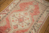 Angled view of a vintage Oushak runner's stepped medallion in soft cantaloupe, ivory, and charcoal.