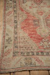 Stepped contour border and worn pile of a vintage Turkish Oushak rug in melon and charcoal.