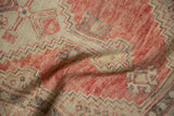 Softly folded vintage Oushak rug revealing the distressed texture and low-pile geometric design.