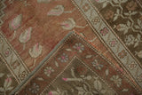 Vintage Distressed Melas rug corner reveals even pile wear, olive green selvage, hand-knotted reverse.