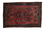 Antique Fine Sarouk rug with an expressive field of palmettes and floral vines in teal and gold on a ruby red ground.