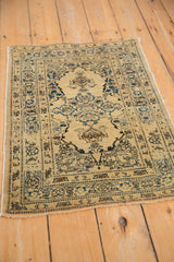 A three-quarter view of a fine antique Persian Tabriz rug with a floral medallion.