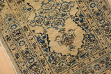 Low pile of an antique Tabriz rug showing intricate floral patterns with time-softened patina.