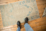Worn texture and sky blue motif on a distressed vintage Oushak rug.