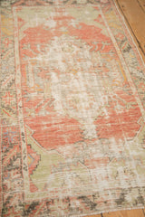 The time-softened texture and low pile of a distressed vintage Turkish Oushak rug.