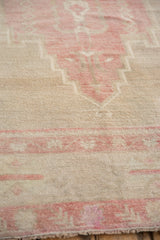 Short, even pile and hand-knotted texture of a distressed Turkish Oushak in pink and platinum.