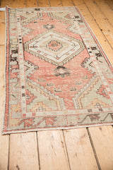 Distressed Oushak runner detail with dusty rose, seafoam geometric patterns, and mostly even wear.
