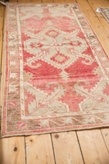 Perspective view of a vintage Oushak runner with a time-softened blush and platinum palette.