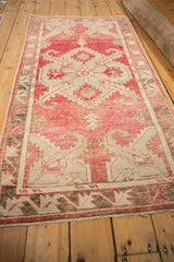 Angled perspective of the vintage Oushak runner, highlighting its distressed texture and full length.