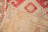Detail of the hand-knotted foundation and secured side cord on the vintage Oushak rug's reverse.