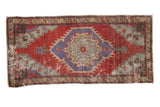 Vintage distressed Oushak rug mat with a shield medallion in cherry red, slate blue, and antique ivory.