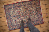 Overhead view of the hand-knotted Persian Isfahan rug's intricate floral field and detailed borders.