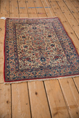 Angled view of a vintage Isfahan rug highlighting its dense floral field and intricate borders.