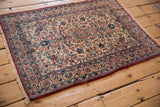 Angled perspective of a vintage Isfahan rug, detailing its intricate floral field and multi-layered border.