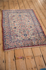 Angled view of a vintage Isfahan rug highlighting the texture of its dense floral pile.