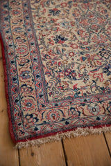 Finely detailed floral border and short kork wool pile on a vintage Persian Isfahan rug corner.