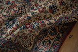 A fold across the vintage Isfahan rug reveals the soft texture of its high-density kork wool pile.