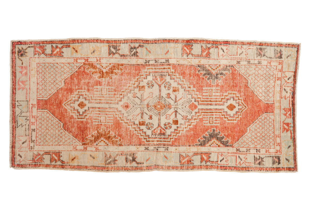 Vintage distressed Oushak rug runner with a stepped geometric medallion in madder red, charcoal, and copper tones.