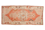 Vintage distressed Oushak rug runner with a stepped geometric medallion in madder red, charcoal, and copper tones.