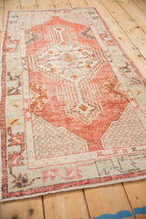 Distressed Oushak runner seen from an angle, showcasing its full length and soft color palette.