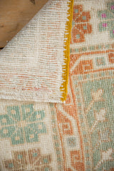 Hand-knotted foundation and saffron side cord of a vintage distressed Turkish Oushak rug.