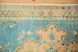 Distressed vintage Turkish Oushak rug detail: germinating border, sky blue field, even wear.