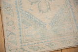 Distressed ivory pile, soft blue patterns, and original selvage of a vintage Dosemealti rug.