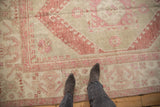 Evenly worn pile and soft abrash on a distressed Oushak carpet in dusty burgundy and ivory.