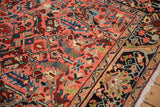 Vintage Heriz runner's detailed navy border, blush geometric field, and hand-knotted texture.